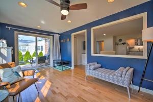 a living room with blue walls and a ceiling fan at Cape May Quad with Grill - 7 Blocks to Beach! in Cape May