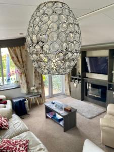 a living room with a large ball hanging from the ceiling at 2 Bedrooms & Double Sofa bed Deluxe Superior Holiday Home in Gisburn
