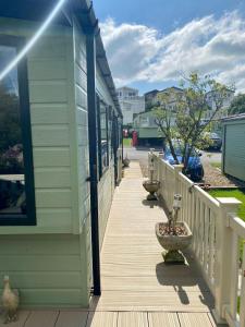 a porch of a house with some plants on it at 2 Bedrooms & Double Sofa bed Deluxe Superior Holiday Home in Gisburn