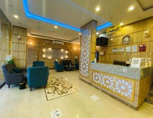 a lobby with chairs and a bar in a hotel at فندق الميار , Al Mayar Hotel in Medina