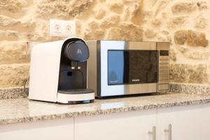 a microwave oven sitting on top of a counter at Landras de Compostela in Santiago de Compostela