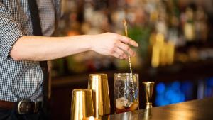 a bartender making a drink at a bar at Hotel Indigo Lower East Side New York in New York