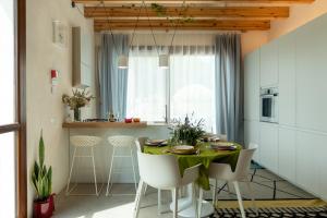 eine Küche und ein Esszimmer mit einem Tisch und Stühlen in der Unterkunft Zu Bastianu House in Alcamo