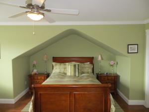 a bedroom with a bed and a ceiling fan at Lancaster Inn B&B in Bonavista