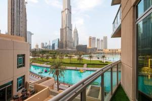 a view of the city from the balcony of a building at FIRST CLASS 2BR with full BURJ KHALIFA and FOUNTAIN VIEW in Dubai