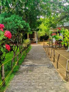 a path in front of a house with flowers at Lobster Inn in Trincomalee