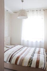 a bedroom with a bed with a large window at Sunny Stay Apartment in Świnoujście