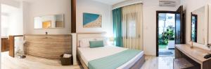 a bedroom with a bed and a mirror and a sink at Villa Irina sea view in Sykia Chalkidikis +117 photos