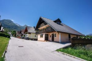 a house on the side of a road at Apartmaji Gorenc in Bohinj