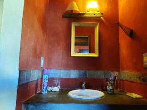 a bathroom with a sink and a mirror at Complejo La Pausa in Punta Del Diablo +26 photos