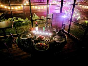 a table with plates of food and lights on it at Kokomo INN Bed and Breakfast Ottawa-Gatineau's Only Tropical Riverfront B&B on the National Capital Cycling Pathway Route Verte #1 - for Adults Only - Chambre d'hôtes tropical aux berges des Outaouais BnB #17542O in Ottawa +89 photos