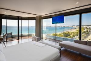 a bedroom with a bed and a view of the ocean at Yacht Hotel in Vlorë