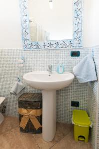 a bathroom with a sink and a mirror at Giaco's Rooms in Villasimius