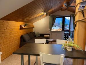 a living room with a table and a couch at Roof Heaven Ferienwohnung in Blaichach