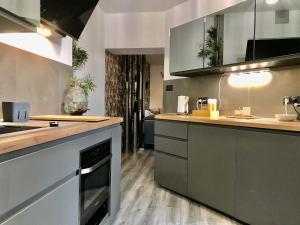 a kitchen with a sink and a stove at Pod Bykiem in Kościerzyna