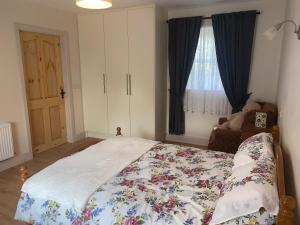 a bedroom with a large bed and a window at Hillview Cottage in Bantry