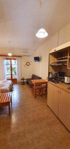 a room with a kitchen and a living room at Nicoll Apartments in Acharavi