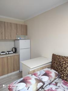 a small kitchen with a table and a couch at Коттедж Науки 65 in Kharkiv