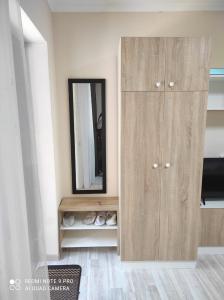 a wooden cabinet in a room with a mirror at Коттедж Науки 65 in Kharkiv