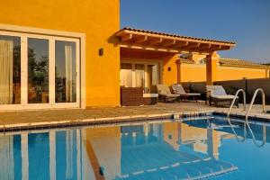 a house with a swimming pool in front of a house at ARILLAS HILLSIDE VILLA 3 - Provence in Arillas +38 photos