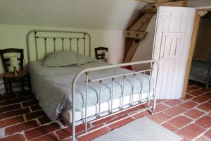 1 dormitorio con 1 cama en una habitación con escalera en LE COTTAGE DES SABLONS près du zoo de Beauval, en Saint-Romain-sur-Cher