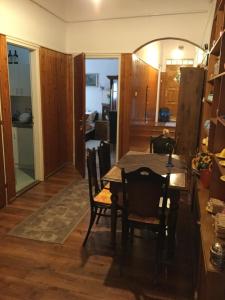 a dining room and kitchen with a table and chairs at Bazilika Vendégház in Eger