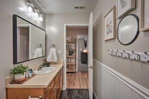 a bathroom with a sink and a mirror at Family-Friendly Home, 6 Mi to Riverwalk Plaza in Bakersfield