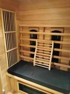 a sauna with a bench in a wooden cabin at Mica beauty & wellness center in Temse +4 photos