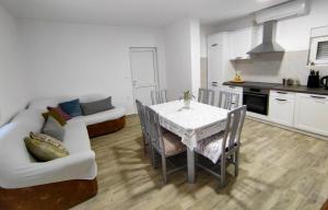 a kitchen and dining room with a table and a couch at Celtis Shade House in Virpazar