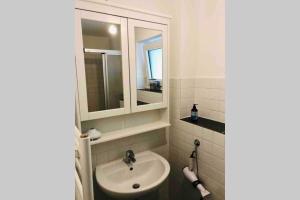 a bathroom with a sink and a mirror at Apartment "Alte Mühle" in Wiehl