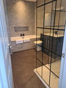 a bathroom with two sinks and a toilet at Royal Seabank Hotel in Blackpool