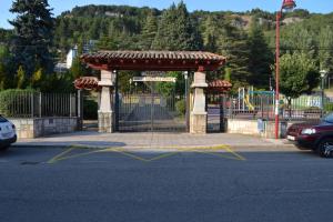 a gate in a parking lot in front of a playground at AguasBlancas VUT LE 446 in La Pola de Gordón