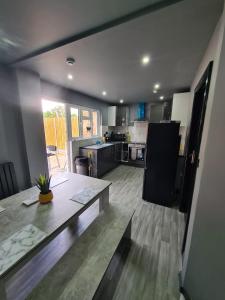 a large kitchen with a table and a counter top at Oxclose studios in Peterborough