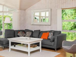 a living room with a couch and a table at 10 person holiday home in V ggerl se in Bøtø By
