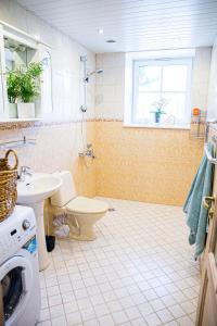 a bathroom with a toilet and a sink at 4 bedroom 166m2 apartment with sauna in the city 600m from the beach in a quiet family residence in Kuressaare