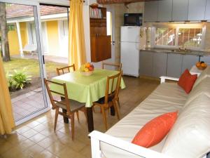 a kitchen and dining room with a table and a couch at pucará in Villa Gesell