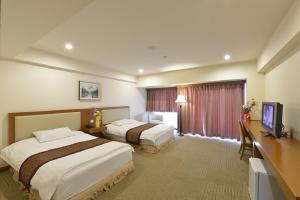 Rúm í herbergi á Fujisan Garden Hotel