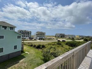 a view of the beach from the balcony of a house at SOUTHERN STAR cottage in Hatteras