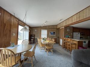 a kitchen and dining room with a table and chairs at SOUTHERN STAR cottage in Hatteras