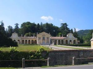 a large house with a fence in front of it at Homely Farmhouse in Pagnano Italy near Forest in Asolo