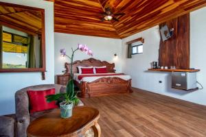 a bedroom with a bed and a wooden ceiling at Hotel Trópico Monteverde in Monteverde Costa Rica