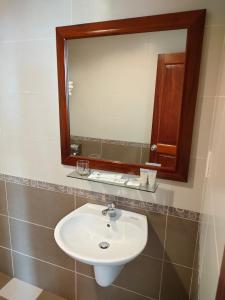 a bathroom with a white sink and a mirror at White Palace 2 in Thái Bình