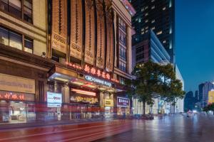 a busy city street at night with buildings at Crowne Plaza Shanghai Nanjing Road by IHG in Shanghai