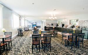 a restaurant with tables and chairs in a room at Super 8 by Wyndham McLean/Bloomington SW in McLean