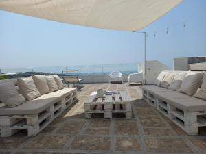 a patio with couches and a table on a roof at la meridiana 2 in Santa Maria al Bagno