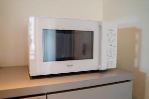 a microwave oven sitting on top of a counter at HOTEL ORIGO HAKATA - Gion - in Fukuoka