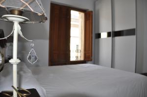 A bed or beds in a room at Apartamentos Principe
