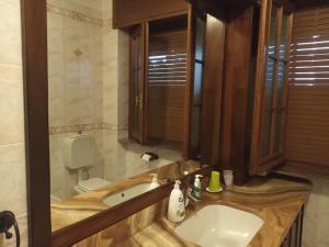 a bathroom with a sink and a toilet at Bed & breakfast Mezzaluna in Feletto +43 photos