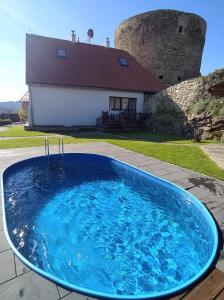 a large blue swimming pool in front of a house at Vila Albrecht Vimperk in Vimperk