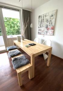 a wooden table and chairs with a table and a window at Harz is calling in Hahnenklee-Bockswiese